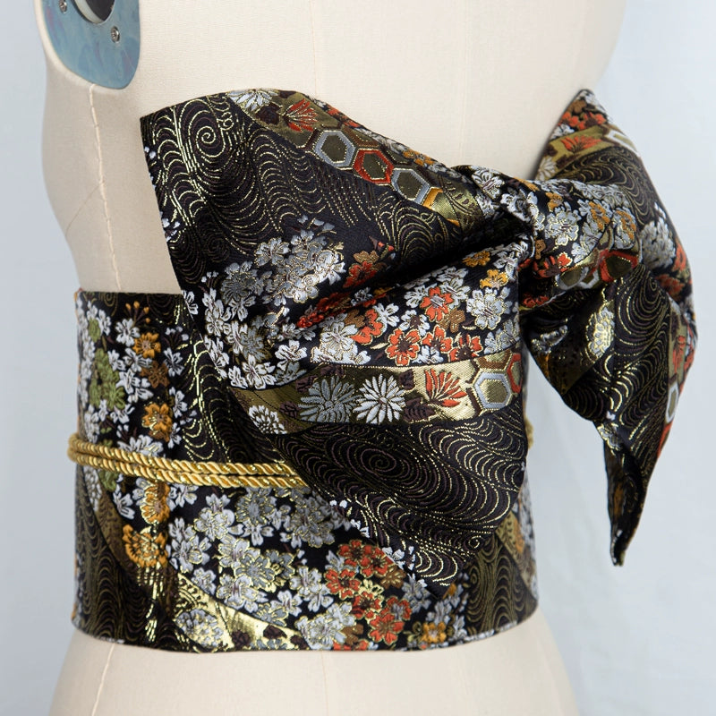 Black floral brocade bow belt styled on mannequin, perfect for Japanese kimono waist seal and yukata fashion for cultural events.