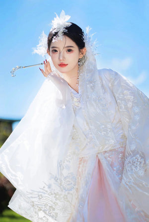 White pink hanbok dress with floral headgear, outdoor sunny setting
