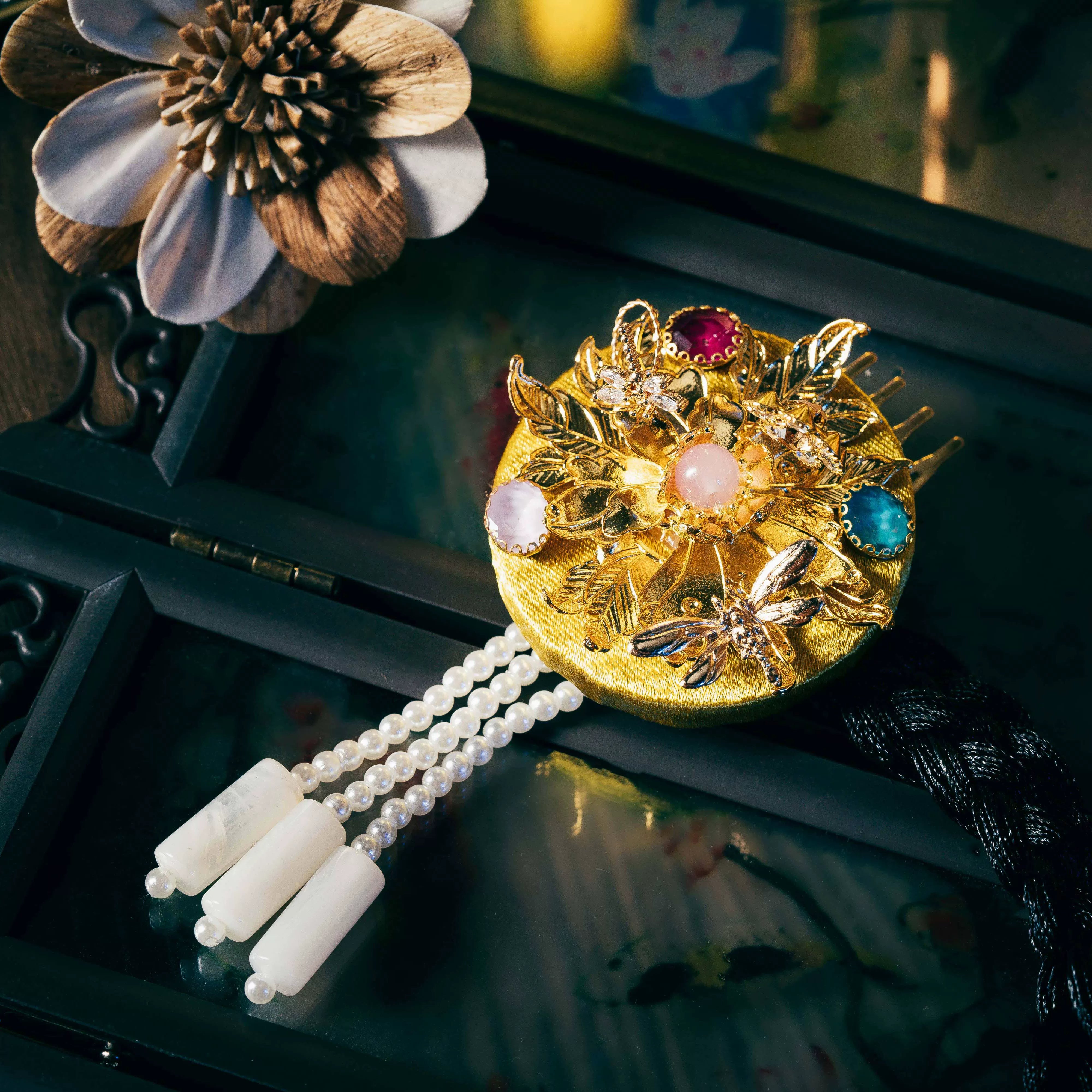 Gold Korean traditional ethnic headgear with intricate gold floral design, gemstone accents, and pearl tassels, finely crafted.