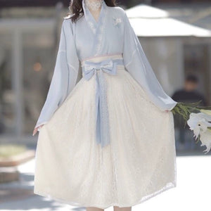Front view of Blue Modern Hanfu Dress with floral lace skirt and ribbon belt, perfect for spring fashion and cultural events.