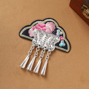 Black embroidered Guizhou Miao fridge magnet with butterfly silver fringe, handmade ethnic decor for kitchen or home.