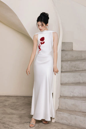 Full-length white beaded evening gown with draped shoulder panels