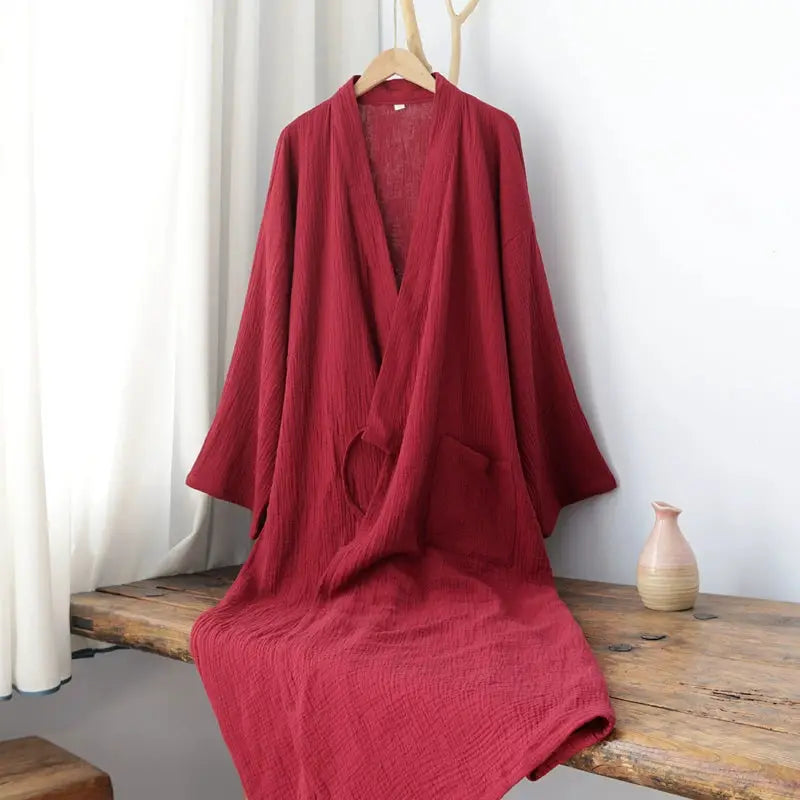 Red pure cotton Hanfu-style Zen robe displayed on a bench, featuring a loose fit and front pocket for stylish summer loungewear.