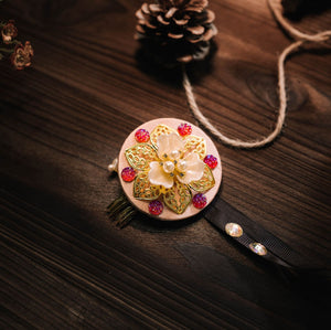 Korean traditional headgear with pink gems and gold floral design on beige base, ideal for cultural fashion styling.