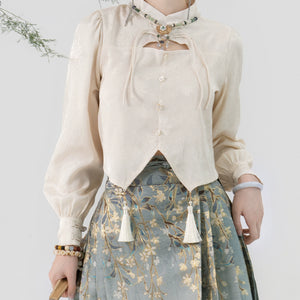 Cream Hanfu blouse with tassel accents and floral embroidery, paired with a Ming-style horse skirt for a vintage look.