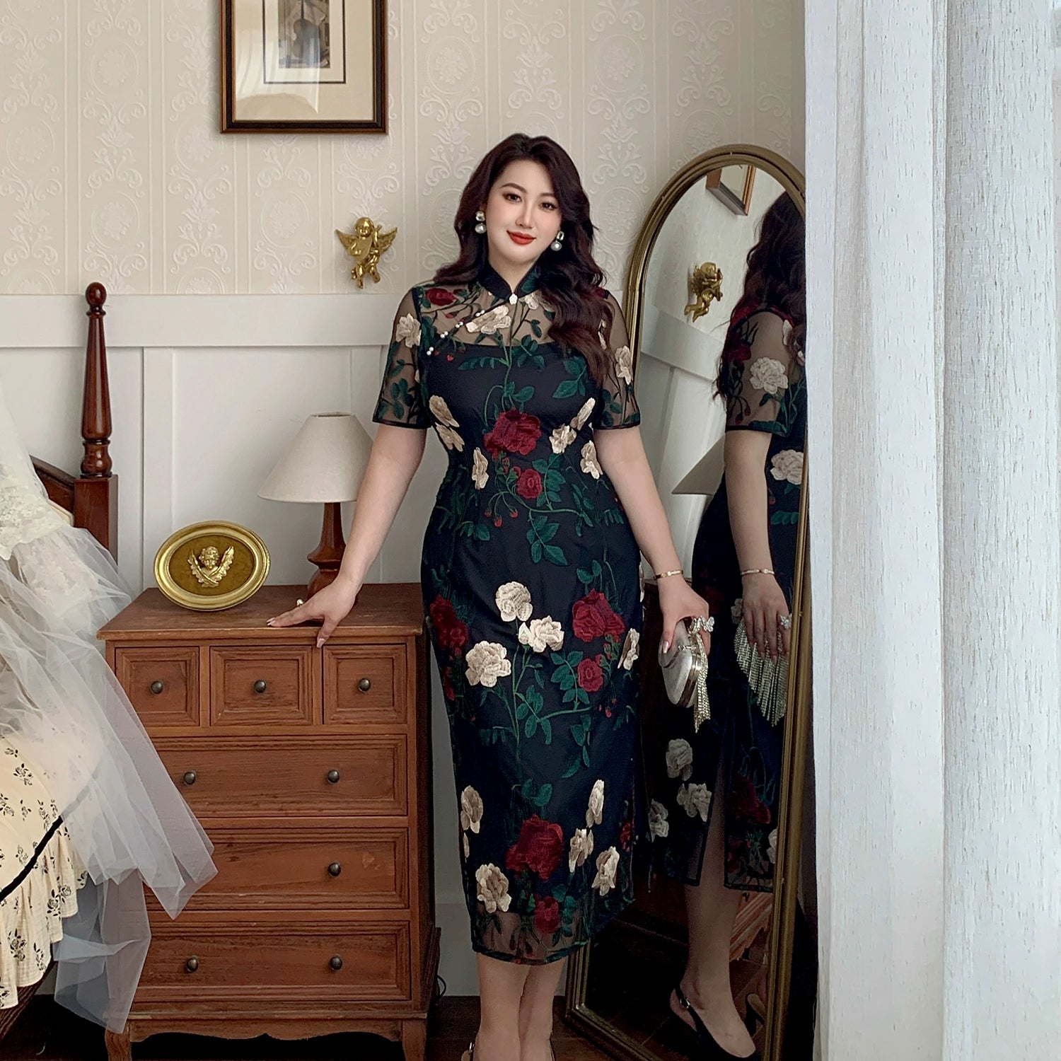 Black plus size cheongsam with floral lace embroidery, modeled in a vintage bedroom with mirror reflection for China style fashion.