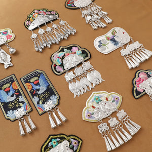 Assorted Guizhou Miao handmade fridge magnets with colorful embroidery and silver fringe, perfect for ethnic-inspired kitchen decor.