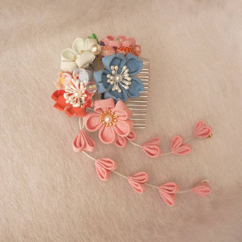 Colorful Japanese crepe hair accessory with pink, blue, and white flowers and dangling petals, ideal for kimono and Hanfu fashion.