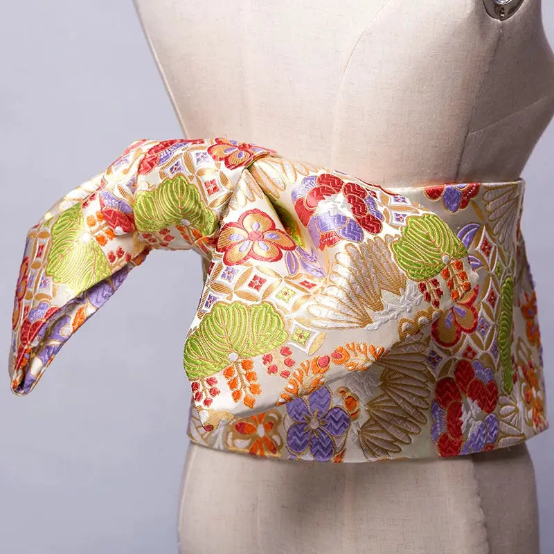 Ivory and multicolored brocade Yukata bow belt with intricate floral designs. A refined kimono waist belt for a sophisticated look.