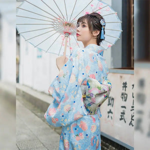 Moonlight Kimono in light blue with floral patterns, featuring a cute girly style. A gentle Japanese yukata dress with elegant obi and matching accessories.