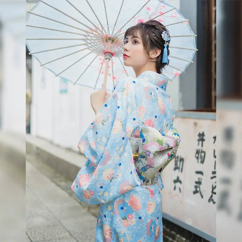 Moonlight Kimono in light blue with floral patterns, featuring a cute girly style. A gentle Japanese yukata dress with elegant obi and matching accessories.