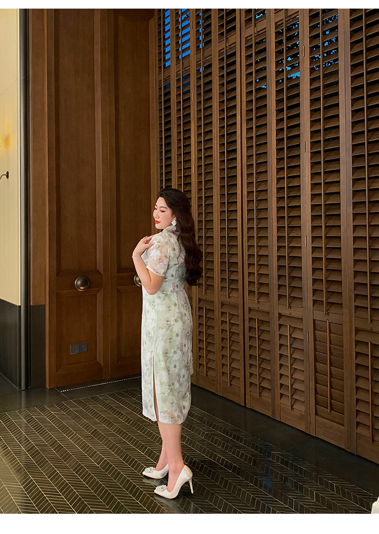 Back angle of modern green plus size qipao dress with floral pattern and side slit, ideal for formal Chinese fashion occasions.