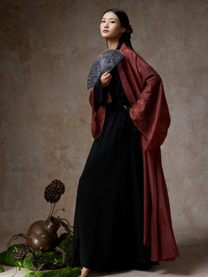 Black dress with wine red cardigan, fan, traditional decor