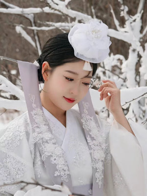 White Yanji Hanbok court dress with lavender collar and floral embroidery, styled for traditional Korean winter fashion.