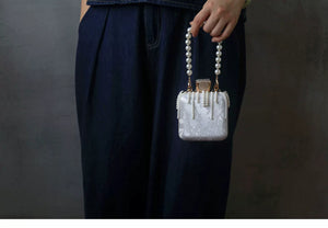 Full styling view showing the small scale of the handbag