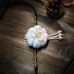Traditional Korean White Hanbok headdress with pearl strands and floral motif, inspired by Yanji Folk cultural design.