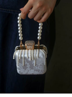 Front view of the clasp and hanging pearl-style beads