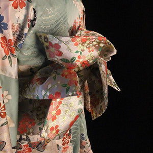 Close-up of Brocade Premium Styling Bow Waist Seal with shimmering floral brocade, highlighting craftsmanship in kimono accessory fashion.