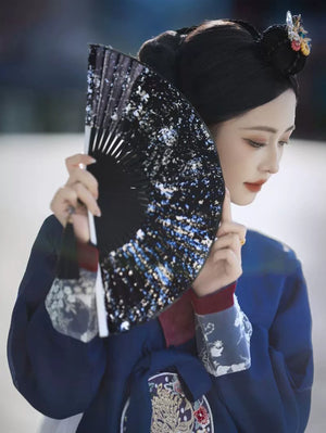 Woman in blue hanbok holding decorative black patterned fan, detailed embroidery - Yandan_Hanfu