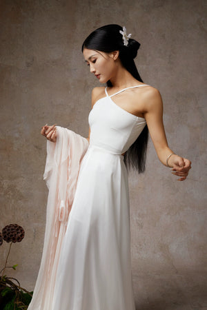 Elegant white halter maxi dress with flowing high-slit skirt for dance/evening wear