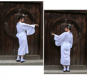 Model wearing a white Yukata Kimono with feather weaving, displaying its flowing sleeves and traditional silhouette. A blend of comfort and style.
