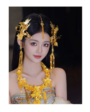 Front view of bride in ornate gold Chinese dragonfly hairpin with delicate fringe, perfect for engagement ceremonies.