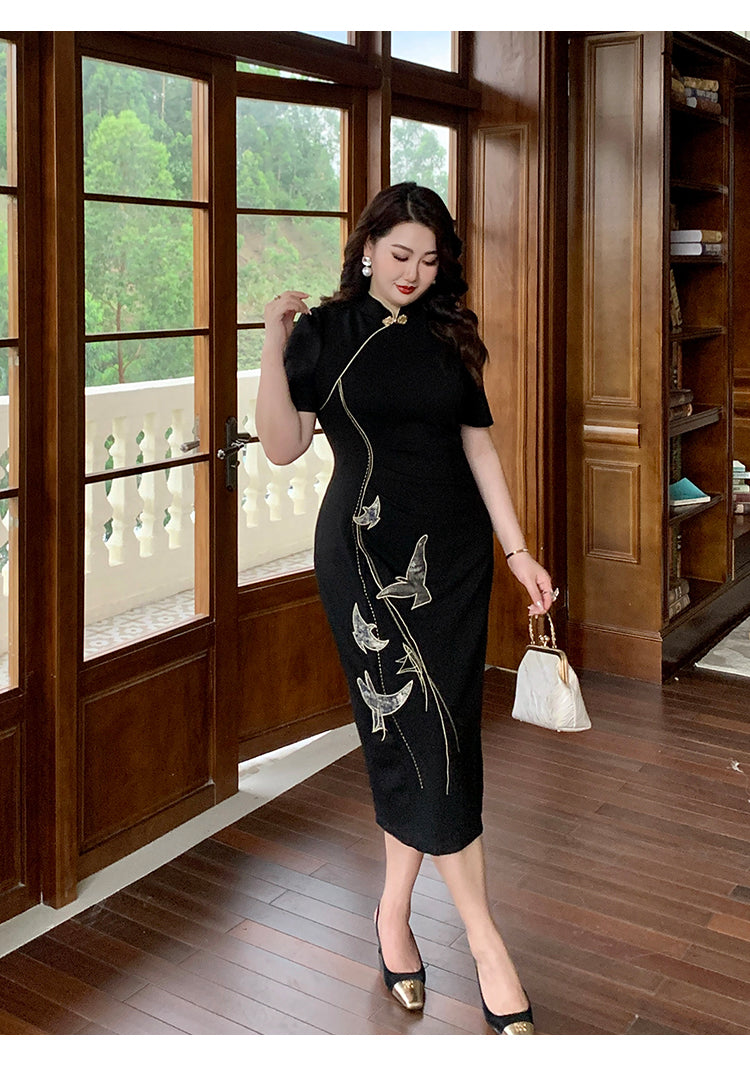 Elegant plus size black cheongsam with gold embroidery, modeled in a luxurious room with wood flooring and balcony view.