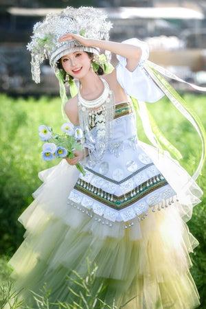 Green version of Pink Miao Clothing Women's Summer Cake Green Dress with floral bouquet and silver headpiece in a grassy field.