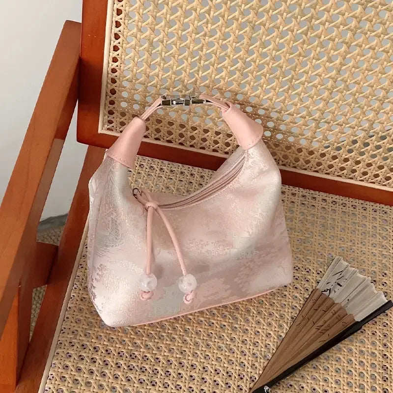 Traditional Chinese handbag accessory with silk embroidery and graceful cheongsam styling.