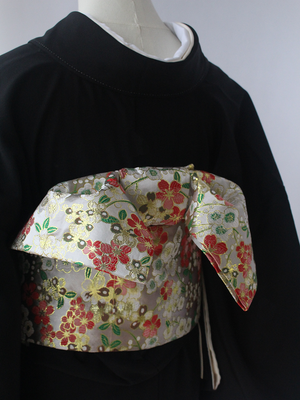 Brocade Premium Styling Bow Waist Seal on black kimono, featuring gold and red floral patterns. A refined accessory for formal kimono wear.