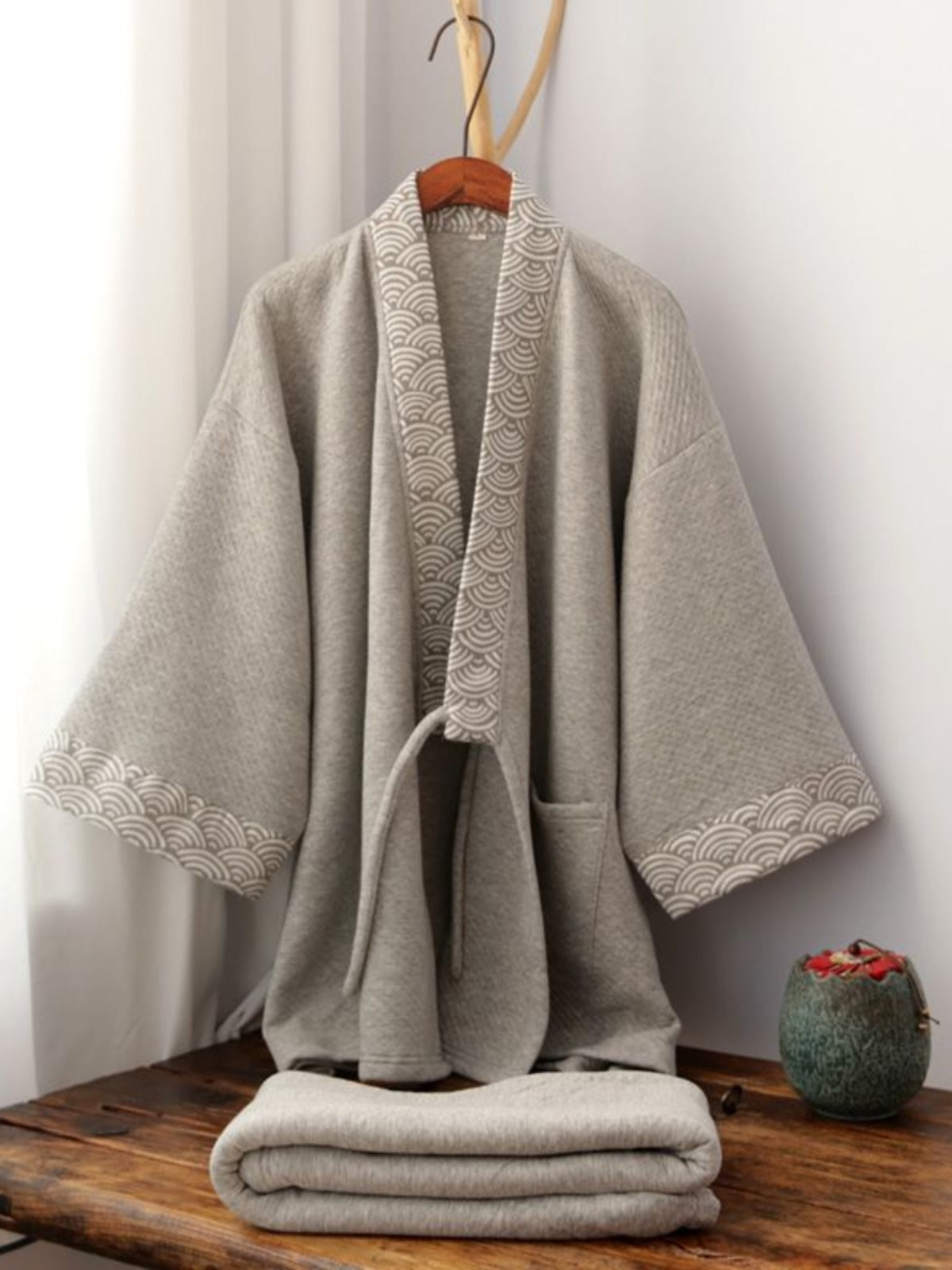 Thickened trousers pajamas set Chinese style gray Hanfu loungewear with wave-pattern trim, displayed folded on a wooden bench.