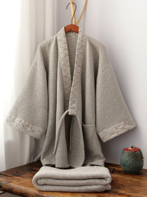 Thickened trousers pajamas set Chinese style gray Hanfu loungewear with wave-pattern trim, displayed folded on a wooden bench.