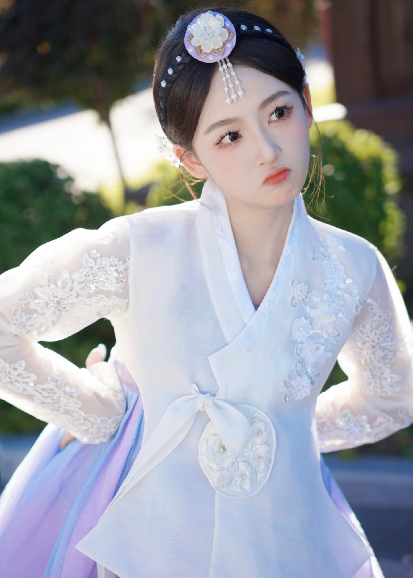 Detailed view of white purple Korean female high-end genuine Yanji court hanbok with floral embroidery and expressive facial pose.