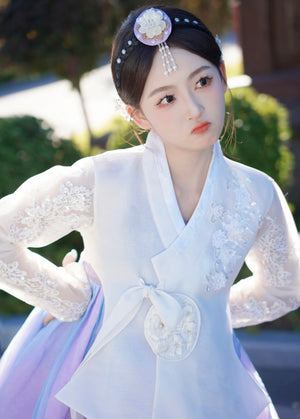 Detailed view of white purple Korean female high-end genuine Yanji court hanbok with floral embroidery and expressive facial pose.