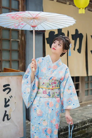 Cute girly-style kimono yukata in light blue with delicate floral patterns. A modified Japanese dress with a soft and elegant aesthetic.