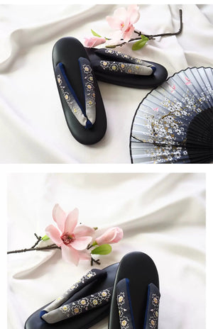 Black Japanese kimono sandals with gold floral embroidery and gradient herringbone straps. A luxurious addition to traditional Japanese outfits.