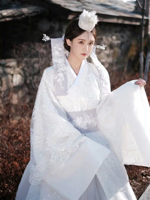 White Yanji Hanbok court dress with intricate embroidery and wide sleeves, showcasing Korean heritage fashion for daily or formal use.