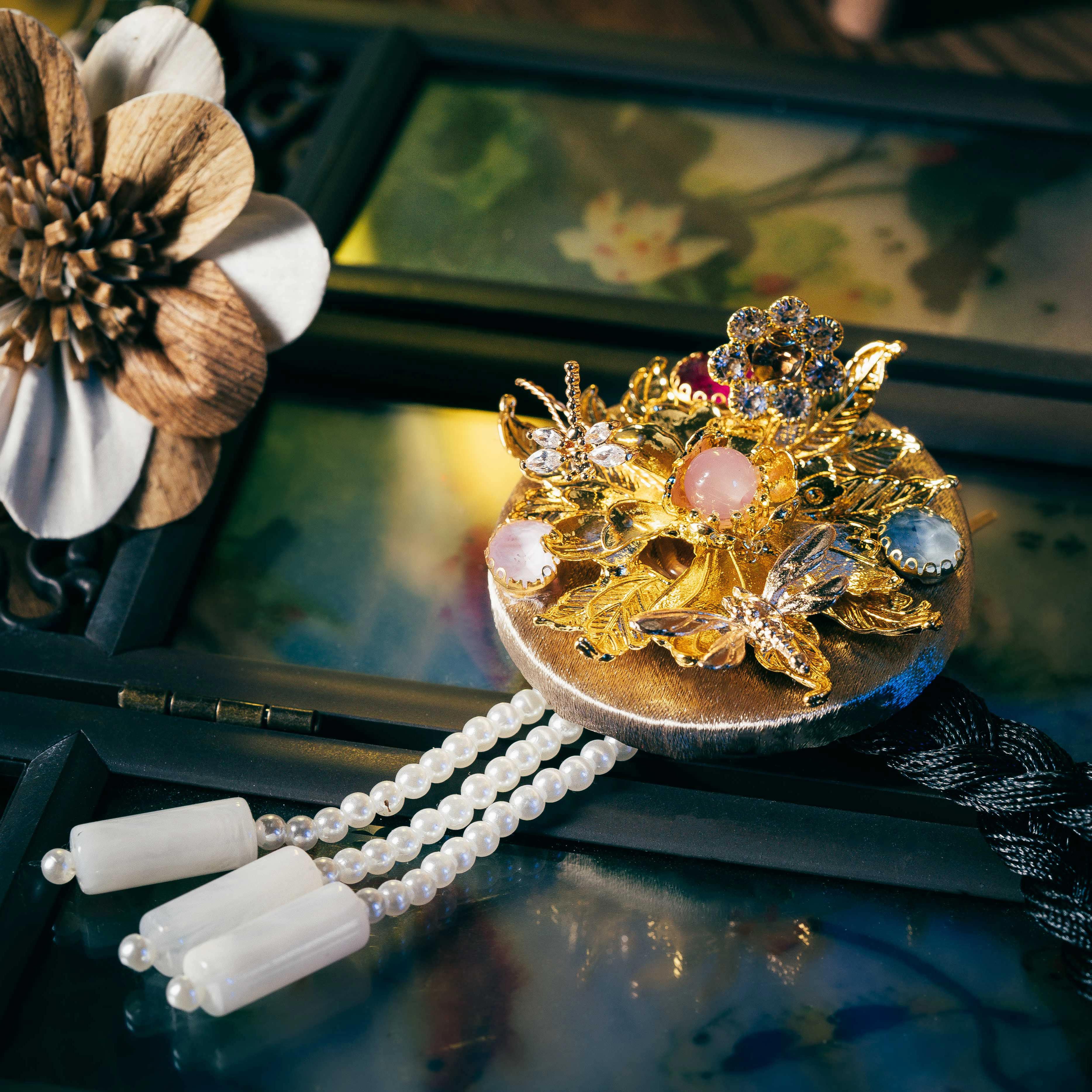Elegant Korean traditional headgear featuring intricate gold leaves, colorful stones, and pearl strands, crafted with precision cutting.