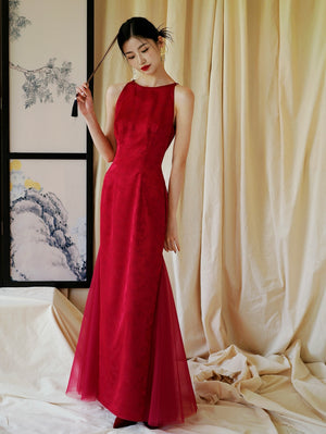 Red cheongsam wedding dress with sheer tulle panels, designed for bridal engagement or toasting occasions.