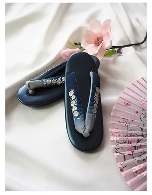 Navy blue Japanese kimono slippers with silver floral embroidery and gradient herringbone straps. A sophisticated choice for formal occasions.