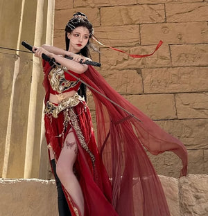 Sacred Flame Western Regions Dancer Classical Clothing Hanfu Women's Exotic Style in red with gold embroidery, posed with sword near ancient stone wall.