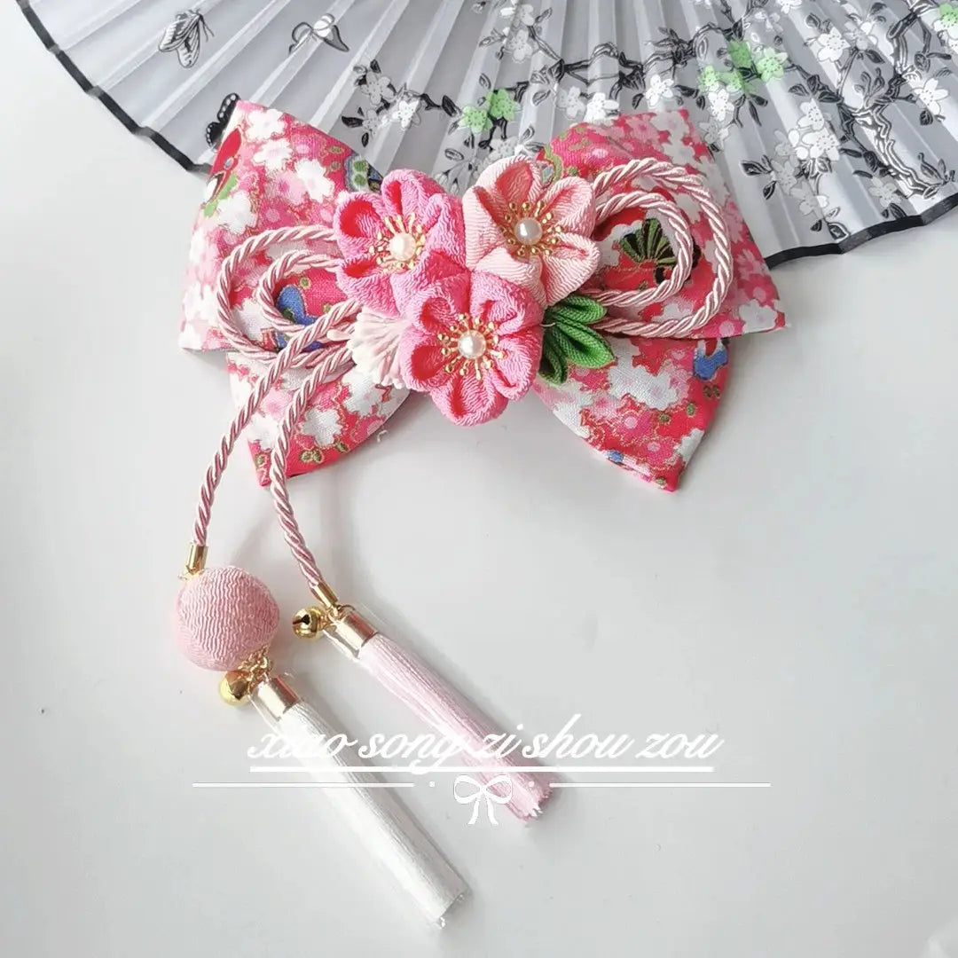 Pink floral Japanese kimono hair accessory with cherry blossoms and tassels, perfect for traditional or cosplay styling.