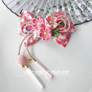 Pink floral Japanese kimono hair accessory with cherry blossoms and tassels, perfect for traditional or cosplay styling.