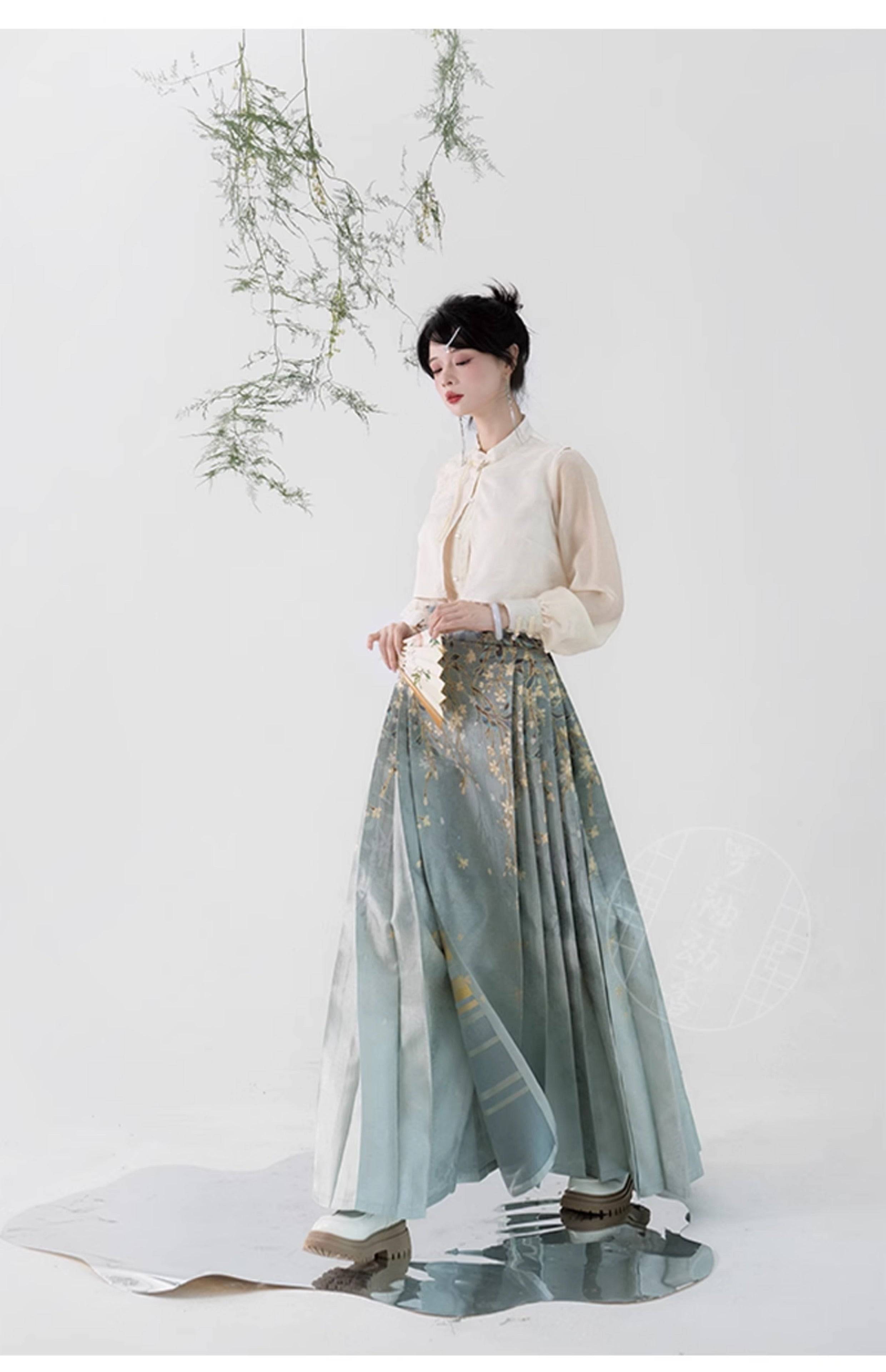 Flowing Hanfu horse skirt with gradient green tones and gold floral patterns, inspired by Ming-dynasty aesthetics.