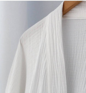 Detailed view of collar and fabric texture of Chinese style pure white Hanfu robe, made from breathable cotton.