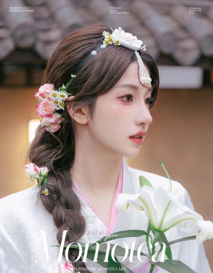 Model wearing white and pink pearl Korean traditional headgear accessory with floral accents, styled with hanbok for a traditional look.