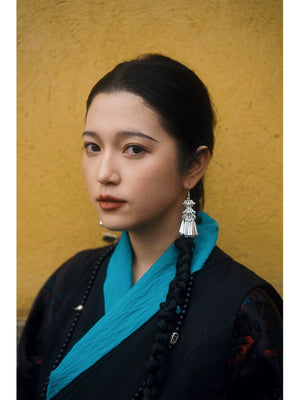 Snow black Xizang dress separates seated lifestyle photo with turquoise cuffs
