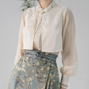 Detailed view of cream blouse and high-waisted Hanfu skirt with gold jasmine embroidery, perfect for traditional wear.