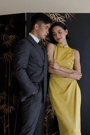 Bride in yellow Cheongsam dress with groom in suit, perfect for traditional Chinese wedding photography.