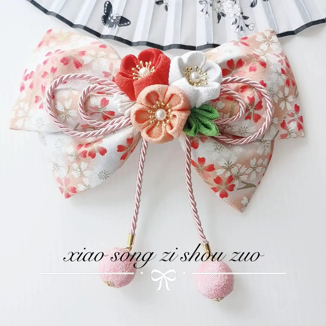Peach floral Japanese kimono hair accessory with orange and white cherry blossoms and soft pink ball tassels.